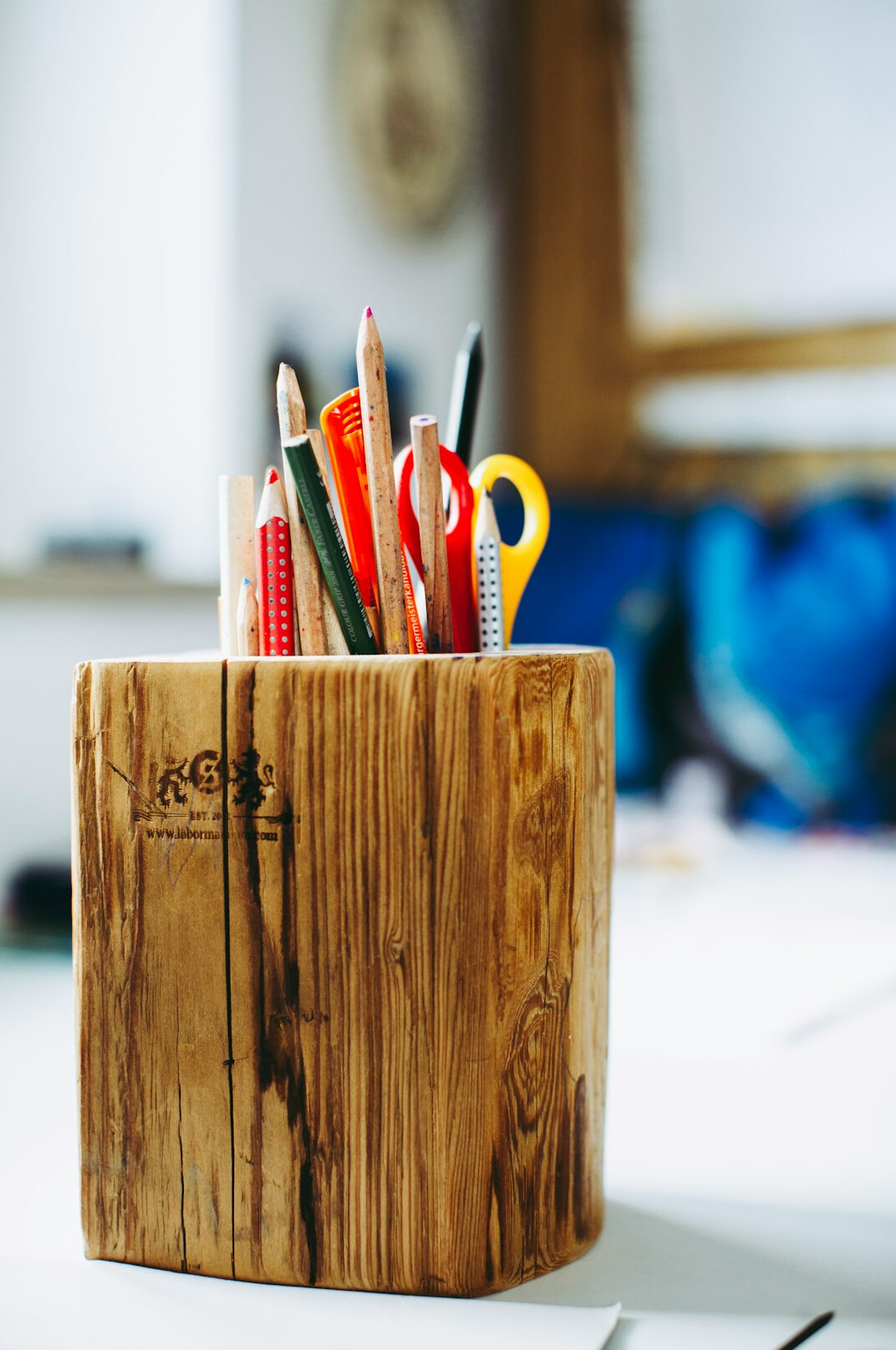 Close-up of handwritten research notes and pens on a wooden desk