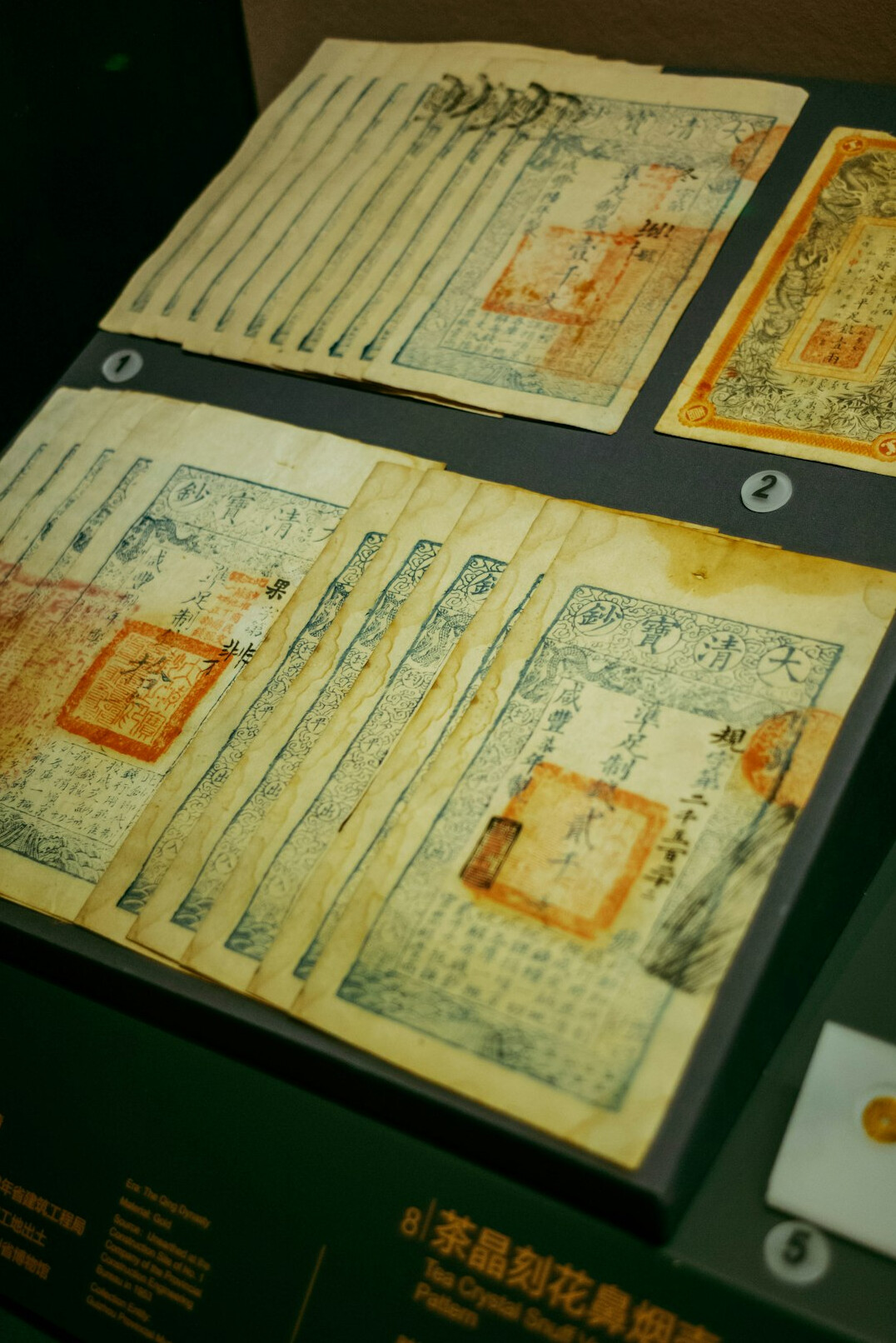 Stacks of aged archival folders and documents in a research archive