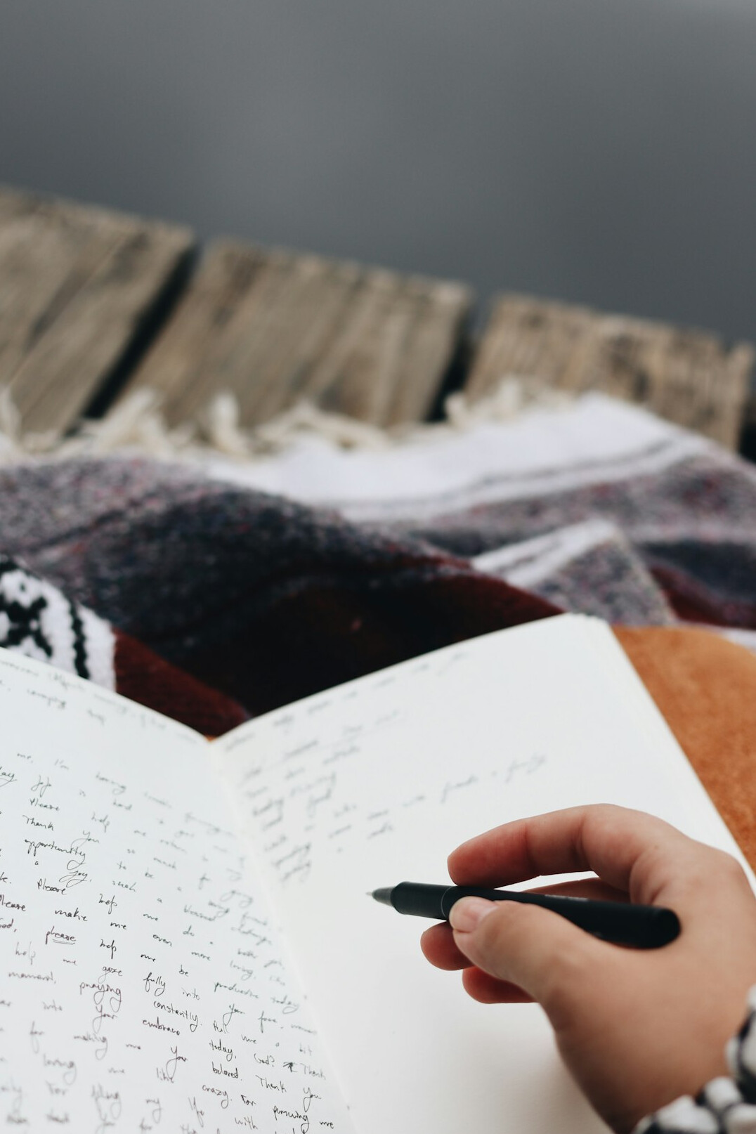 person writing in journal